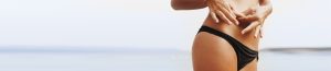 tummy tuck banner of a woman in bikini grabbing her belly fat