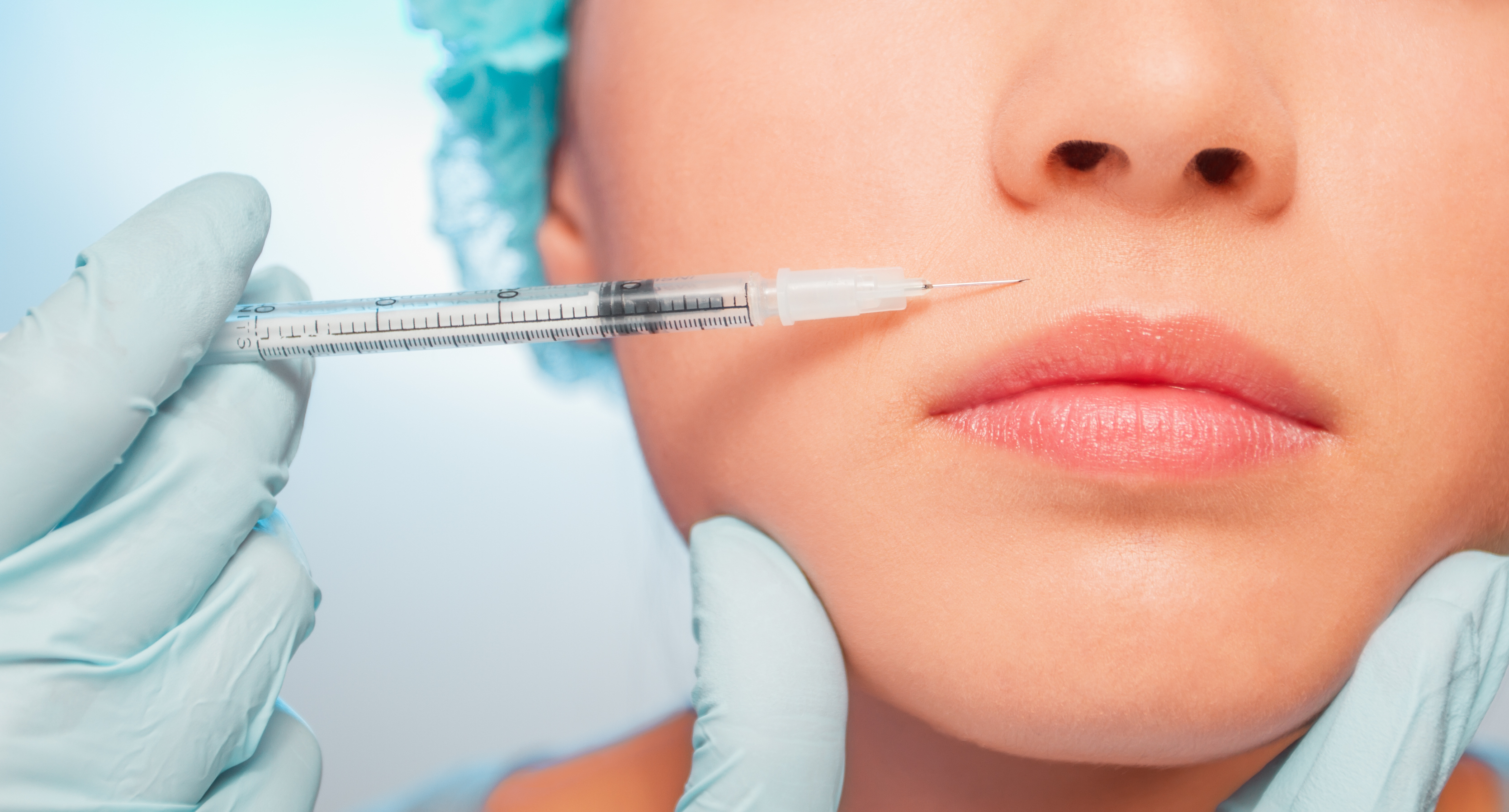 close up of a woman getting a botox injection on her lips&nbsp;