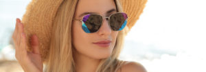 face of a woman wearing a hat and a sunglasses